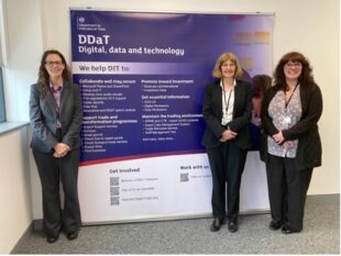 Kathy Gribbin, Project Support Officer, Ann Hughes, Head of Business Operations, and Elaine Roberts, Project Support Officer, stood with our DDaT Week banner in our Darlington office.