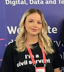 A woman wearing a T shirt saying I am a Civil Servant