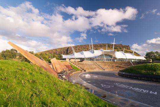 Dynamic Earth. A white pavilion with steps on the side of a hill.