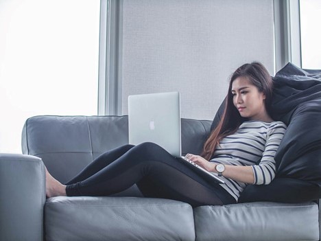 image of woman on sofa with laptop 