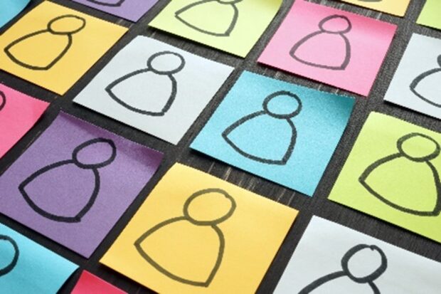 Coloured post it stickers with identical basic cartoon people drawn on them.
