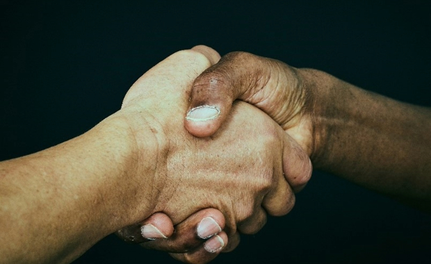 A handshake on a black background.
