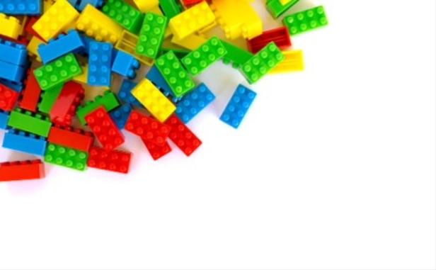 A pile of coloured lego bricks crowded into the top left corner of the picture